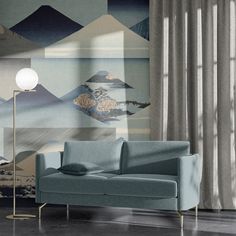 a living room scene with focus on the couch and wallpapered area that looks like it has mountains