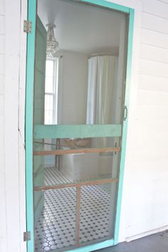 an open door to a bathroom with a shower in it