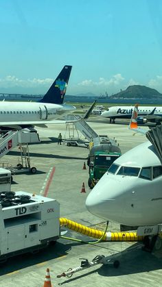 airplanes are parked on the tarmac at an airport