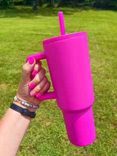 a person holding a pink cup in their hand