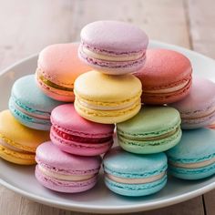 a white plate topped with lots of colorful macaroons