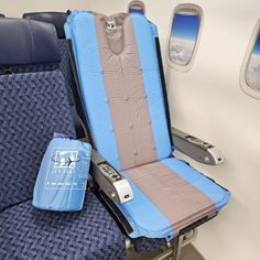 an airplane seat with blue and gray covers