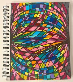 a spiral notebook with an abstract design on the front and bottom cover, in multicolors