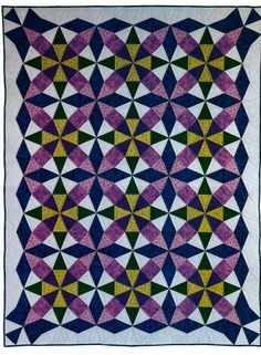 a quilt made with different colors and shapes on the front, side, and back