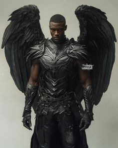 a man dressed in armor with large black wings