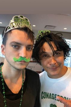 two men with fake moustaches on their faces are posing for the camera