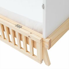 a white mattress sitting on top of a wooden bed frame next to a pillow case