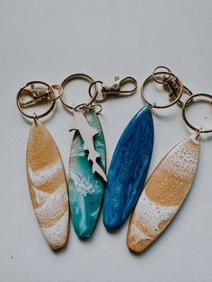 three key chains with different designs on them