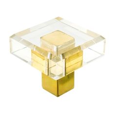 a gold and clear square shaped object on a white background