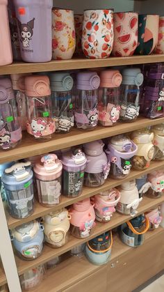 the shelves are filled with many different kinds of cups