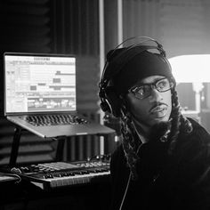 a man wearing headphones sitting in front of a computer