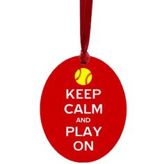 a red ornament that says keep calm and play on with a baseball ball