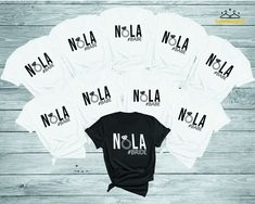 six white t - shirts with the word nola printed on them