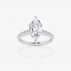 a white gold ring with an oval cut diamond and pave set diamonds around the band