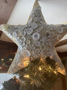 a christmas tree topper with buttons on it