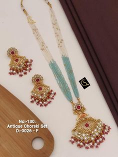 Description :- Kundan Necklace Set/Navrattan Choker/Choker Necklace/Kundan Necklace/ Multicolored Kundan Polki Choker Neckalce Set Gift yourself a royal look with this perfectly crafted kundan necklace set from Manalisstudio. Crafted with high quality kundan stones and pearls, it is impressive in design. The green enamel artwork adds perfect texture to the design. Perfect for weddings and festivities, this antique necklace set should be put on with your favorite sari or lehenga. 100% Satisfactio Navrattan Choker, Moti Set, Antique Necklace Set, Polki Choker, Kundan Necklace Set, Royal Look, Indian Jewelry Sets, Kundan Necklace, Take A Screenshot