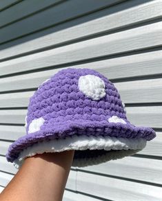 a person wearing a purple and white crocheted hat