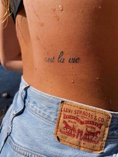 the back of a woman's stomach with words written on it