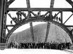 a group of people standing on top of a bridge