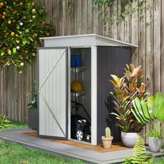 an outdoor storage shed with plants in it