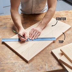 a man is working on some wood with a ruler