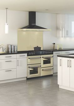 a kitchen with white cabinets and black counter tops is pictured in this image, there are two ovens on each side of the stove