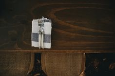 a fork and knife sitting on top of a wooden table next to a white napkin