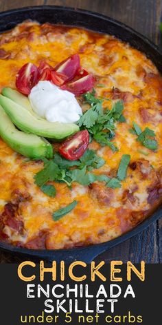 the chicken enchilada skillet is topped with avocado and sour cream