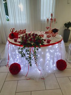 the table is decorated with red roses and lights