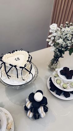 a table topped with cakes and desserts covered in frosting on top of plates