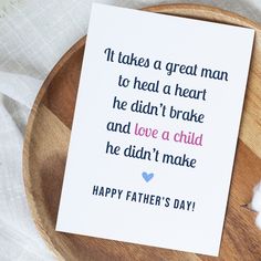 a father's day card sitting on top of a wooden plate next to cotton