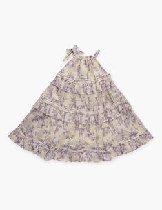 The Halliday Swing Dress in Yellow/Lilac Floral from our Summer Swim 2024 Collection. A cotton printed kids dress featuring an elasticated neckline.