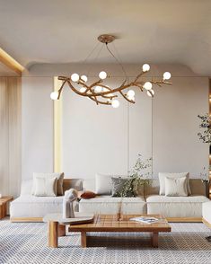 a living room filled with furniture and a large light fixture hanging over the top of it