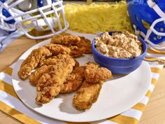 a plate full of fried chicken next to a bowl of oatmeal