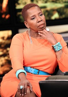 a woman in an orange dress sitting down