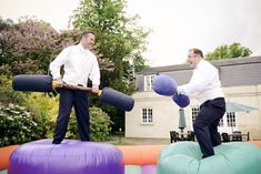 two men standing on top of inflatable balls