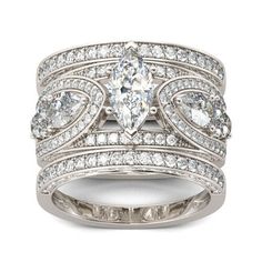 a white gold ring set with pear shaped cut diamonds on each band and an oval center diamond in the middle