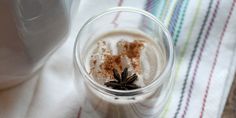 an overhead view of a drink in a glass with cinnamon on the rim and whipped cream