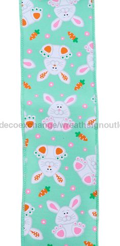 an oven mitt with rabbits and carrots on it, in mint green fabric