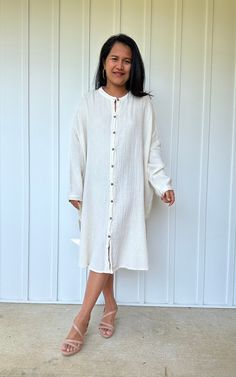 Relax in style with the Aura shirtdress, a unique take on traditional loungewear. Made from breathable double gauze cotton, it's perfect for casual wear out, at home, or even as a beach coverup. The button-down design adds a touch of style and versatility to your wardrobe, ensuring comfort and convenience as you go about your day. Summer Long Sleeve Tunic For Loungewear, Summer Cotton Tunic For Daywear, Spring Relaxed Fit Shirt Dress For Loungewear, White Linen Button Dress For The Beach, White Casual Tunic For Loungewear, Vacation Cotton Tunic Shirt Dress, White Linen Dress With Buttons For The Beach, Cotton Tunic Shirt Dress For Vacation, Relaxed Fit Linen Shirt Dress For Beach