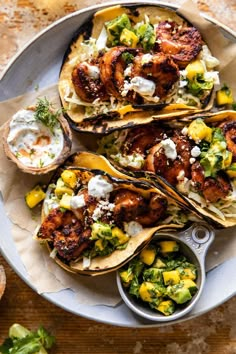 three tacos with shrimp, corn and avocado