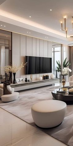 an elegant living room with white furniture and large flat - screen tv on the wall