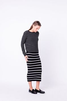 This Stripe Knit Midi Skirt will be your go-to piece for a stylish look. Featuring an elastic waistband to provide flexibility and a flattering fit a fitted bodice and a mid-length hem this skirt will elevate any ensemble. The classic stripes pattern adds a bit of eye-catching texture letting you stand out while remaining timeless. Add this skirt to your wardrobe for a versatile stylish option. Stripe knit skirt Waist elastic band Fitted bodice Midi length Hand wash cold Do not bleach Do not tum Pinstripe Midi Skirt, Striped Relaxed Midi Skirt, Striped Knee-length Relaxed Skirt, Striped Fitted Midi Skirt, Fitted Black Skirt With Vertical Stripes, Knit Midi Skirt, Black Midi Skirt, Knit Midi, Knit Skirt