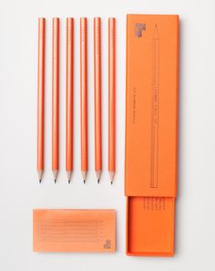 four orange pencils sitting next to each other