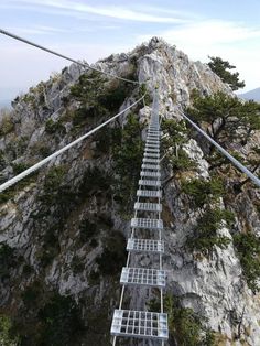 an aerial view of a ladder leading to the top of a mountain