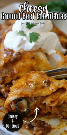 cheesey ground beef enchiladas on a plate with sour cream