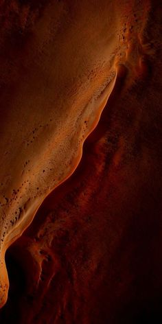 an aerial view of sand and water in the desert, looking down on it's surface