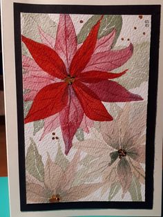 a card with a red flower on it