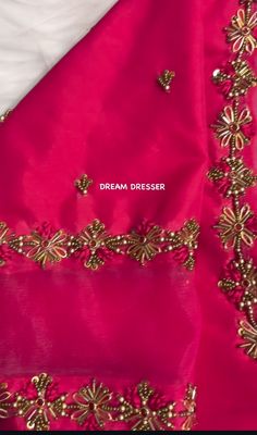 the back of a pink dress with gold embroiderys on it and an embroidered border