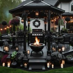 an outdoor gazebo with lit candles in the center and lights on the outside patio